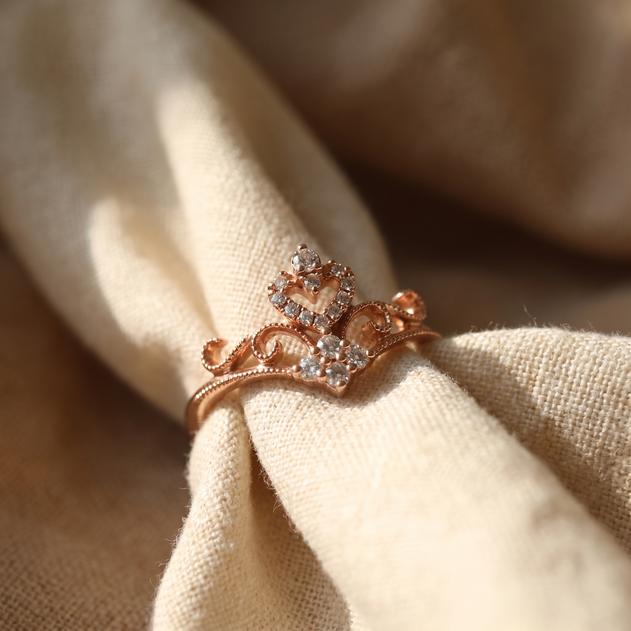 Diamond filigree tiara ring in 18K rose gold, editorial scene on warm linen