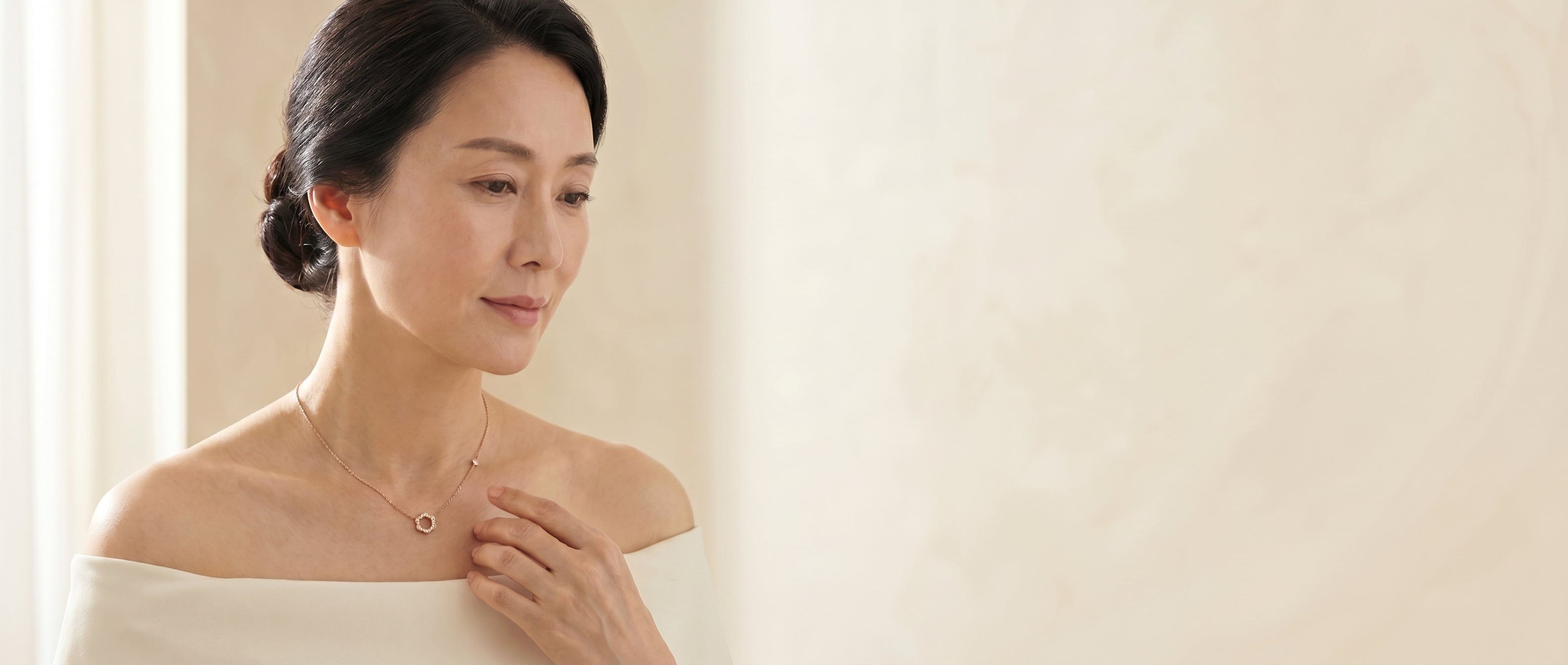 A woman wearing a diamond floral circle necklace